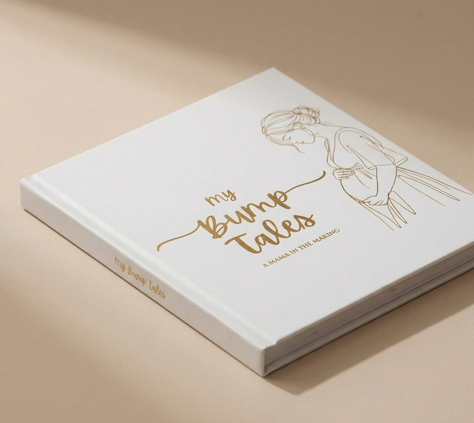 My Bump Tales journal showing gold foil cover detail at angle
